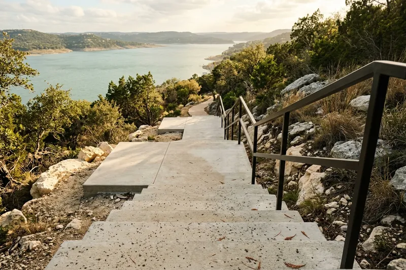 Concrete steps leading down a slope toward a lake