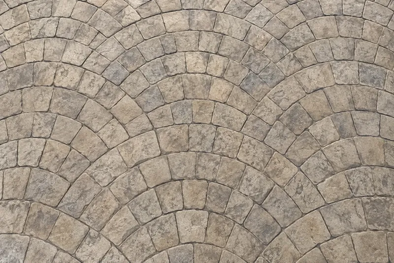 Fan-shaped cobblestone pattern pressed into stamped concrete