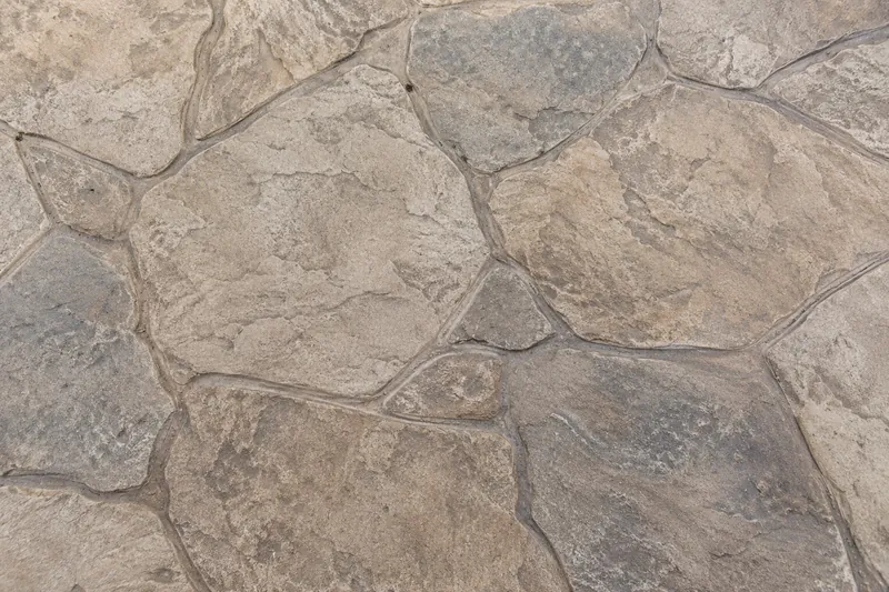 Random flagstone pattern in gray stamped concrete