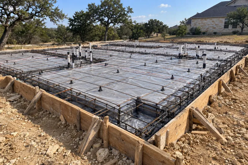 House slab formed with beams, steel and plumbing stubs before the pour