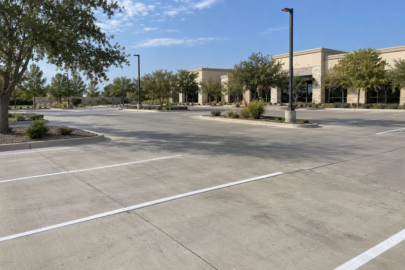 Retail center parking lot with fresh striping and light poles