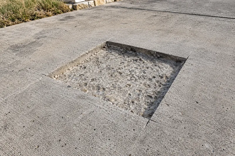 Spalled patch sawn square and chipped out for repair