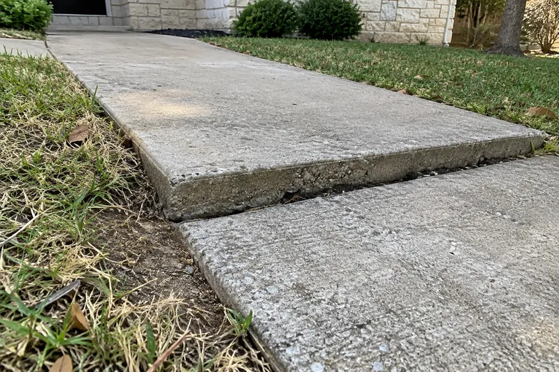 Sunken walkway panel leaving a raised edge at the joint
